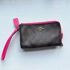 Brown with pink lining lightly used Coach wristlet